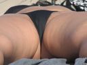 The beautiful wife boldly has her hair coming out of her black bikini!