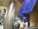 Slender girl in blue skirt spotted on the station platform and positioned behind