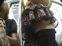 電車内。ドア脇。花柄ミニスカート＆ニーハイソックスの女。