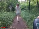 A beautiful model woman is exposed on the promenade of the park in the middle of the day and walks and masturbates with a remote control vibrator in her crotch