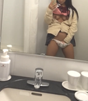 Perverted woman masturbating while taking a selfie in the men's toilet