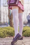 Red-haired slender beauty with pink skirt and absolute area in cherry blossom season