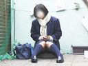 Seated school girl casually shows her panties