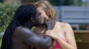 Sex between a jet black black man and a moderately tanned blonde beauty violently entangled in the background of a beautiful sea in outdoor play with an outstanding sense of openness is a fantastic sight www