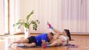 Fitness Rooms - Trainer stretches brunette beauty