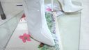 F665 irritably applying paint to long white boots