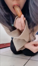유니폼 차림의 그녀가 아래 입에서 소시지를 맛보고 마침내 위쪽 입에서 먹는 영상.