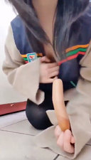 A video of her in uniform tasting sausage in her lower mouth and finally eating it in her upper mouth.