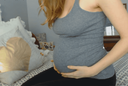 Pregnant woman who is drenched in the month